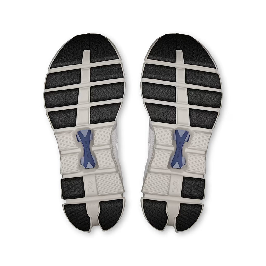 Top view of a pair of running shoes with a white sole and black tread pattern on a white background.
