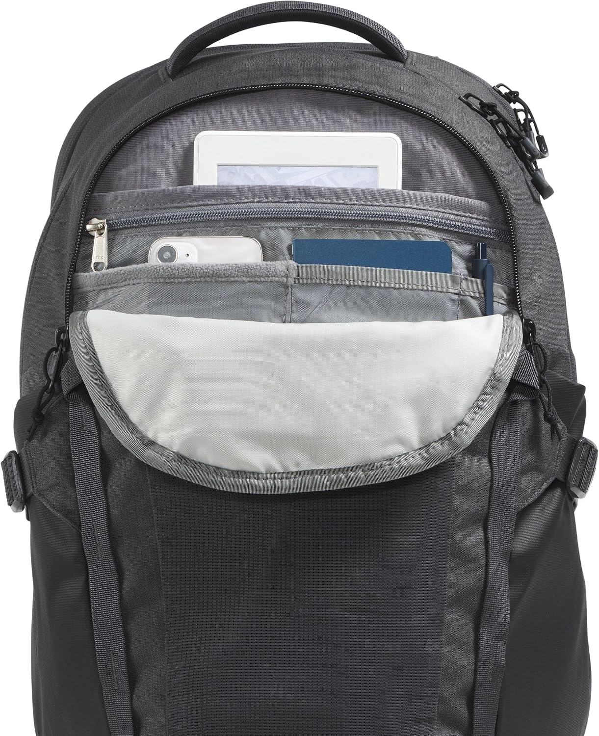 Black backpack with multiple compartments and items inside on a white background