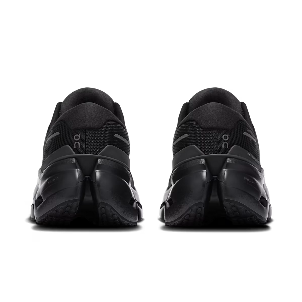 Black athletic shoes with 'oc' branding on a white background
