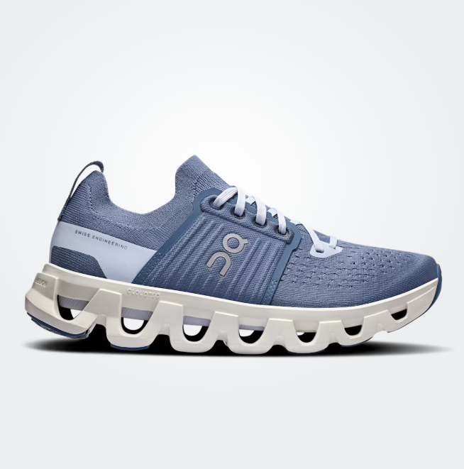 Blue running shoe with white sole on a light gray background