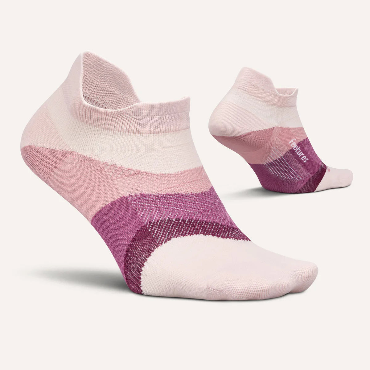 A pair of low-cut ankle socks in a soft pink and purple color-blocked pattern, shown on a light cream background with one sock in the foreground and the other showing the heel and toe from the side.