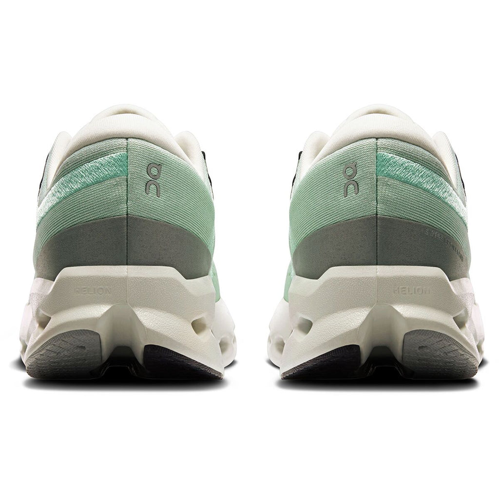 Back view of green and white running shoes on a white background