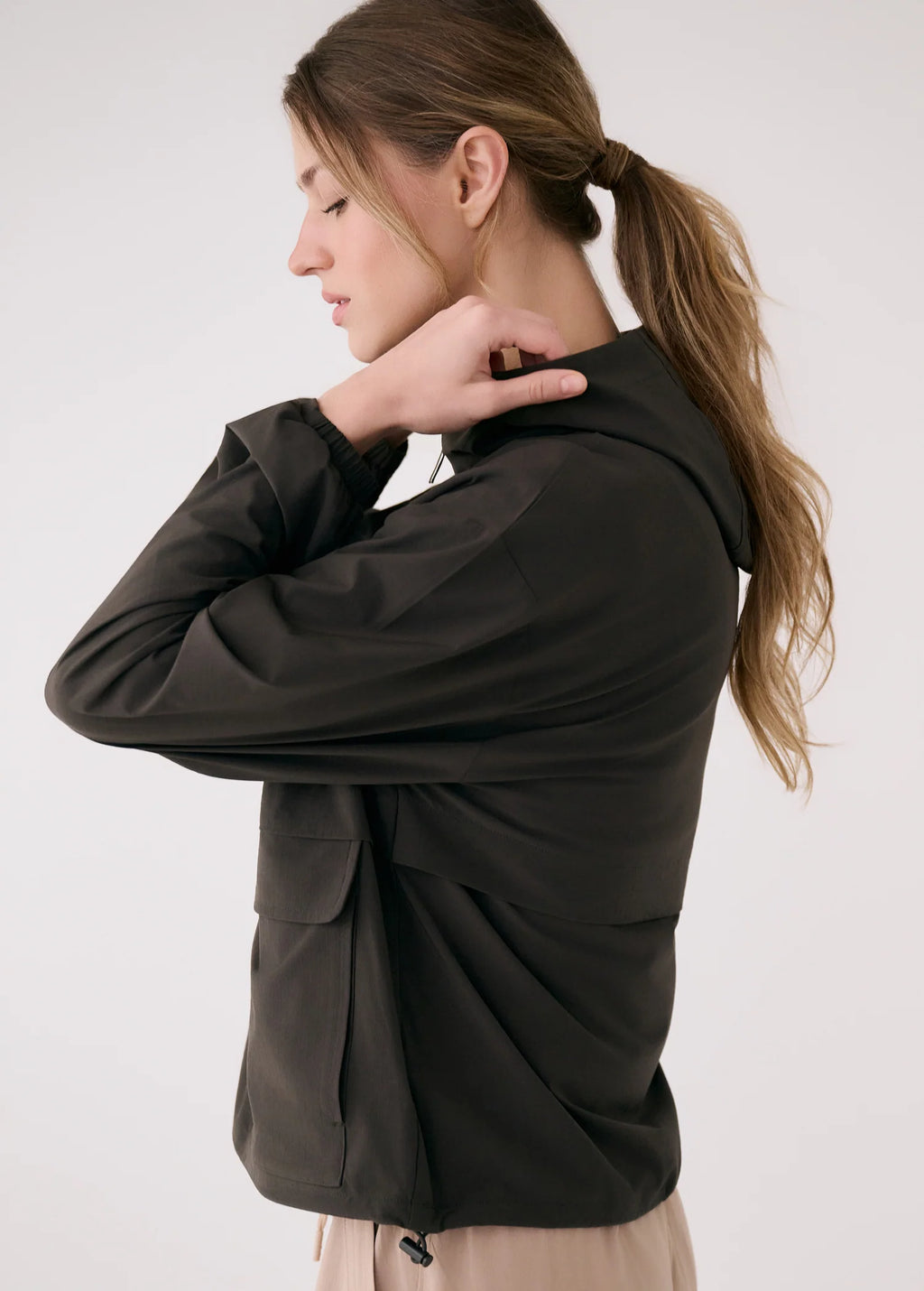 Woman wearing a black jacket against a white background