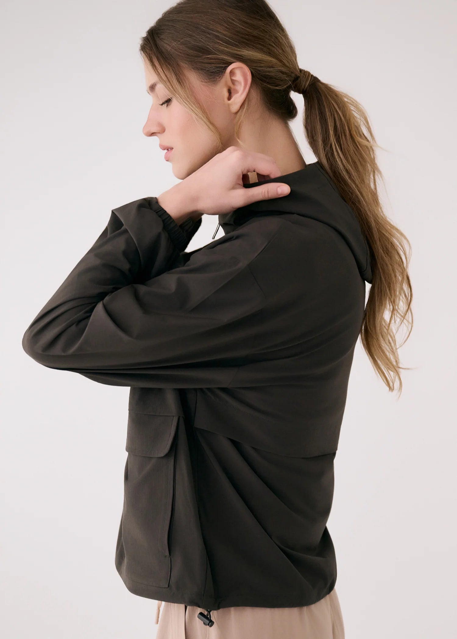 Woman wearing a black jacket against a white background