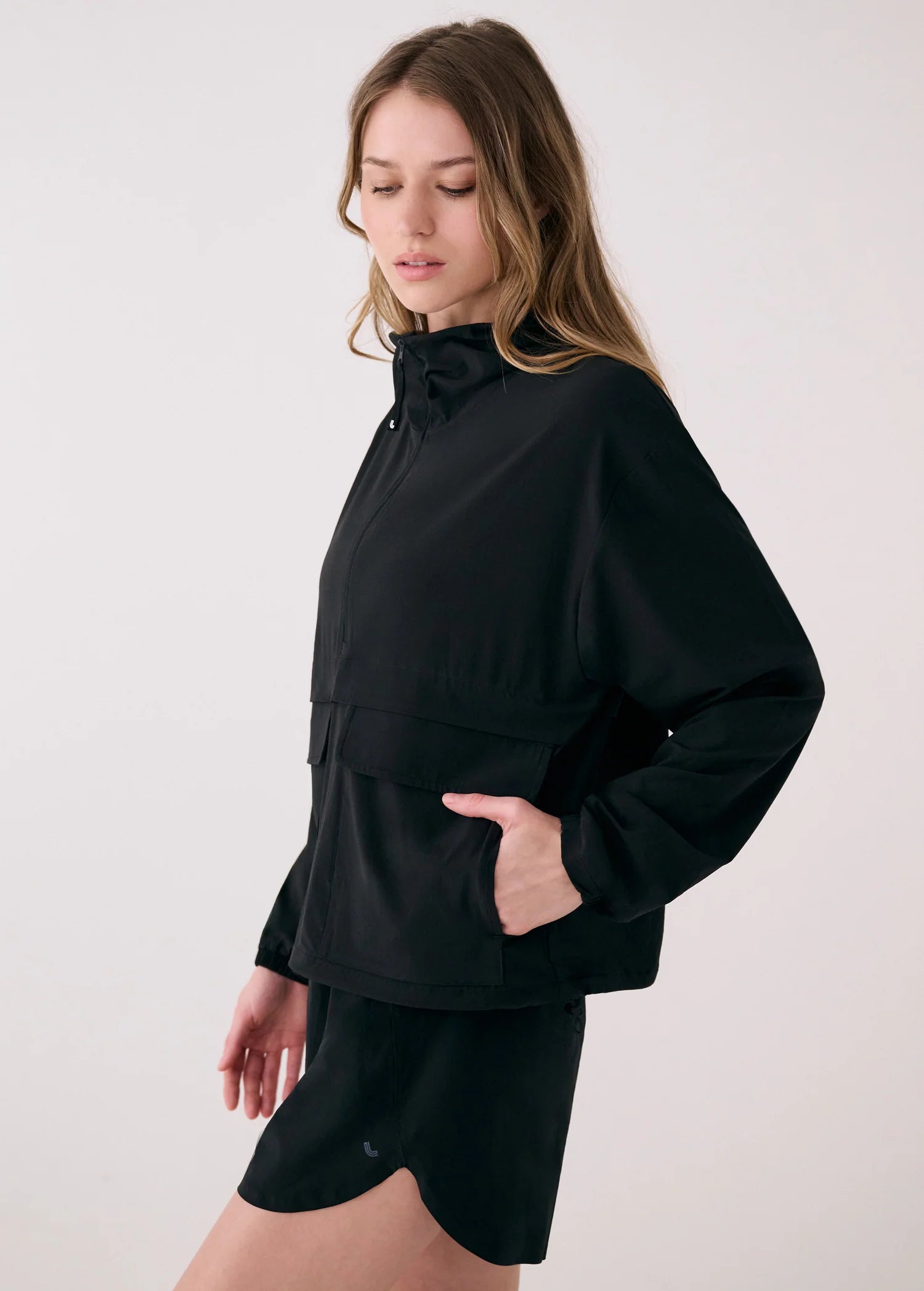 Woman wearing a black outfit on a white background