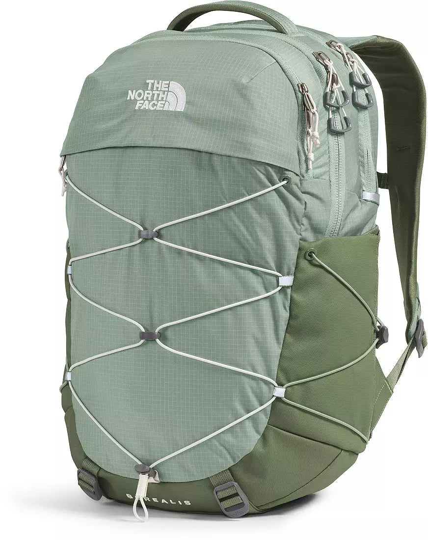 The North Face Salbris backpack in sage green and olive green, featuring a front zippered pocket with caged compression straps, a top handle, and shoulder straps, shown on a white background.