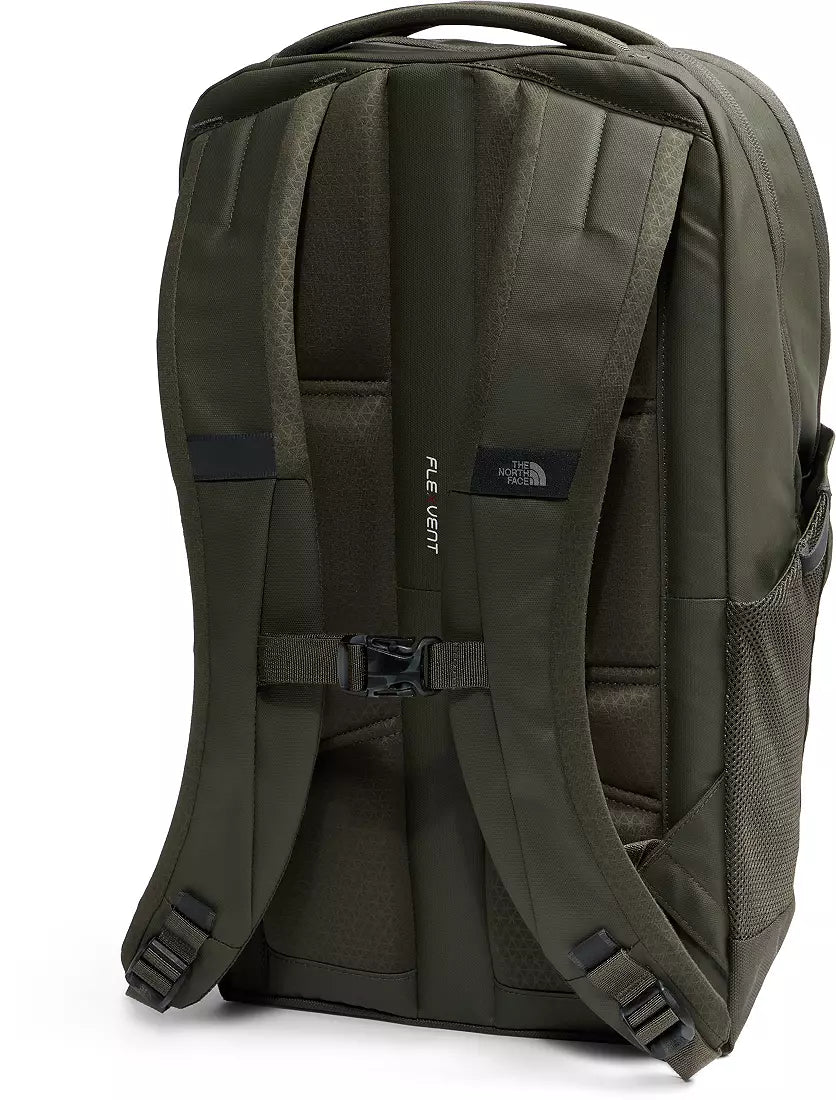 The back view of an olive green backpack by The North Face, featuring padded shoulder straps, a central buckle strap, and a vertical black brand patch.