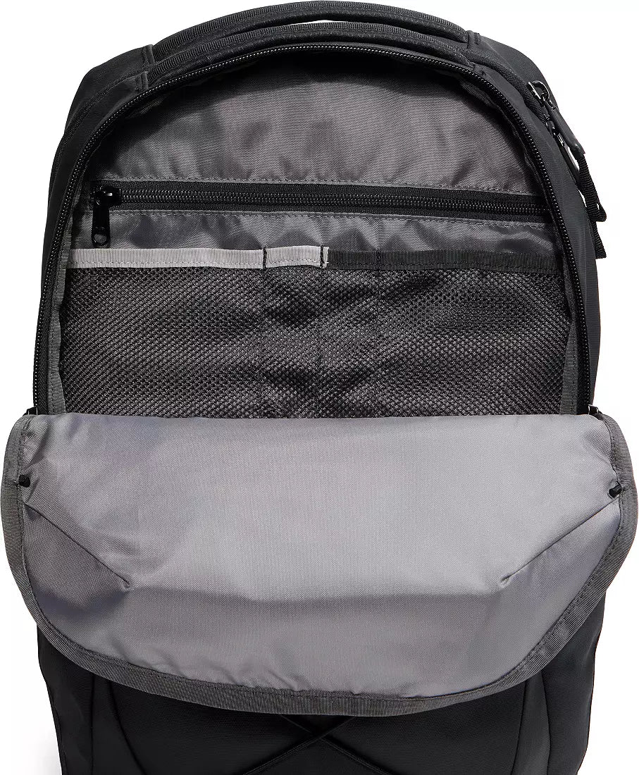 The front compartment of a black backpack is open, showing a gray interior lining, a zippered pocket, a mesh organizer section, and a padded laptop compartment.