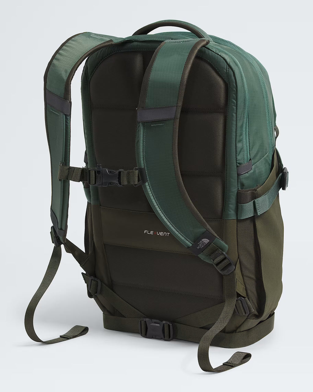 A green and dark brown Fly Vert backpack shown from the back, featuring padded shoulder straps, compression buckles, and side mesh pockets, set against a light gray background.