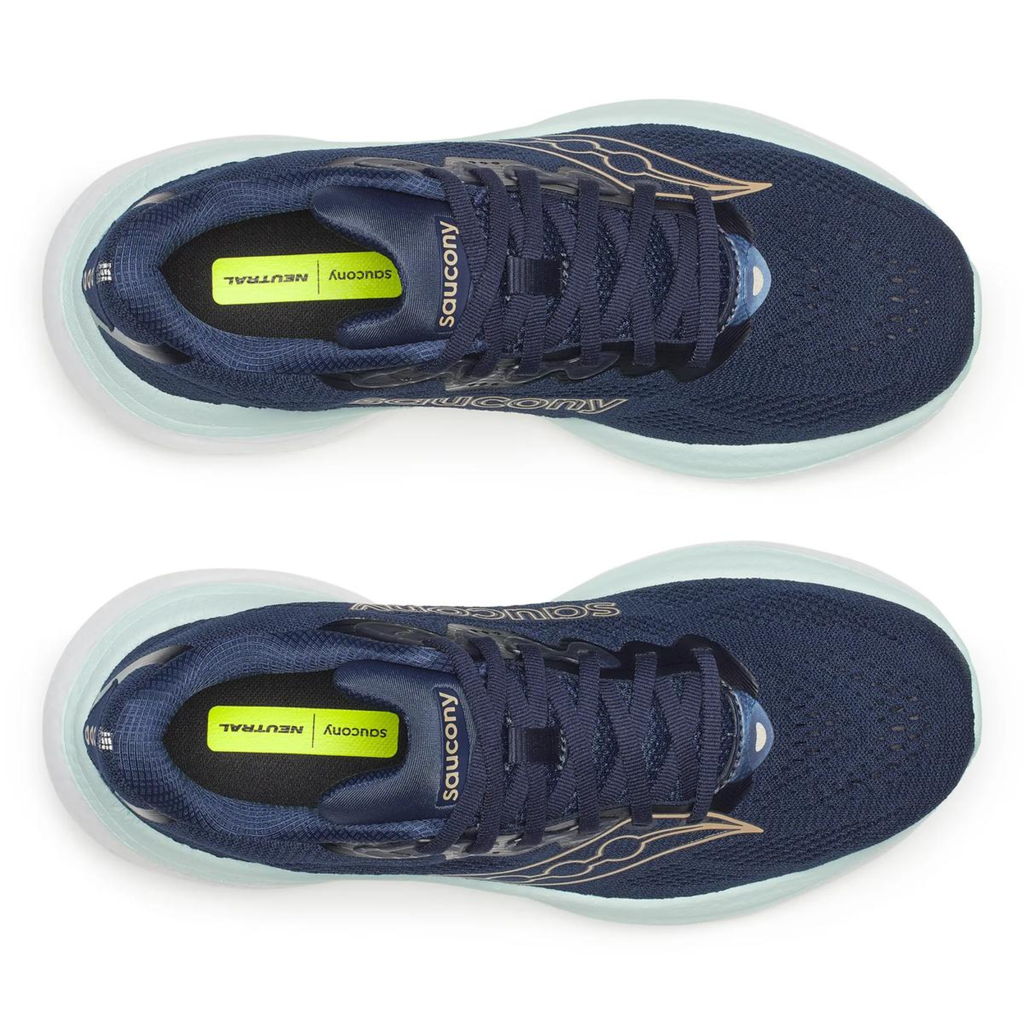 Navy running shoes with white soles on a white background
