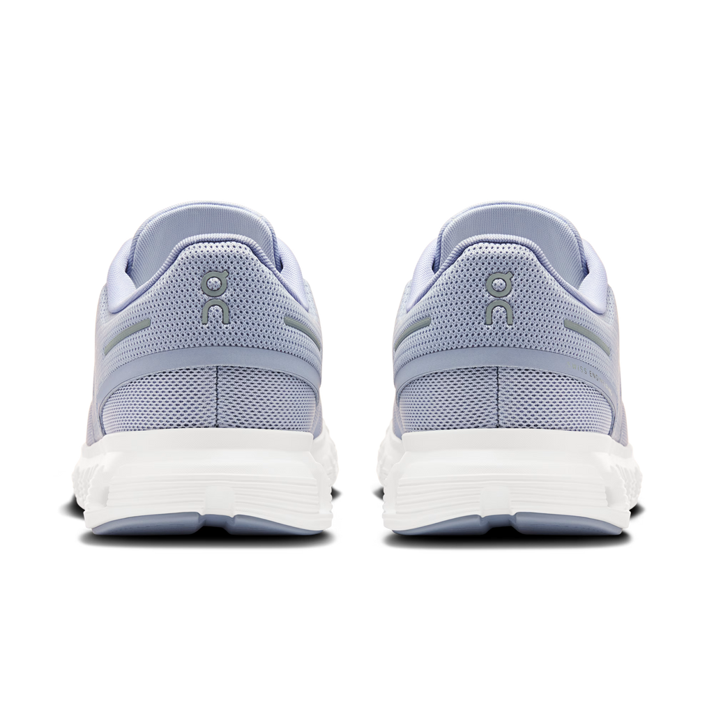 Pair of light blue sneakers with white soles on a white background
