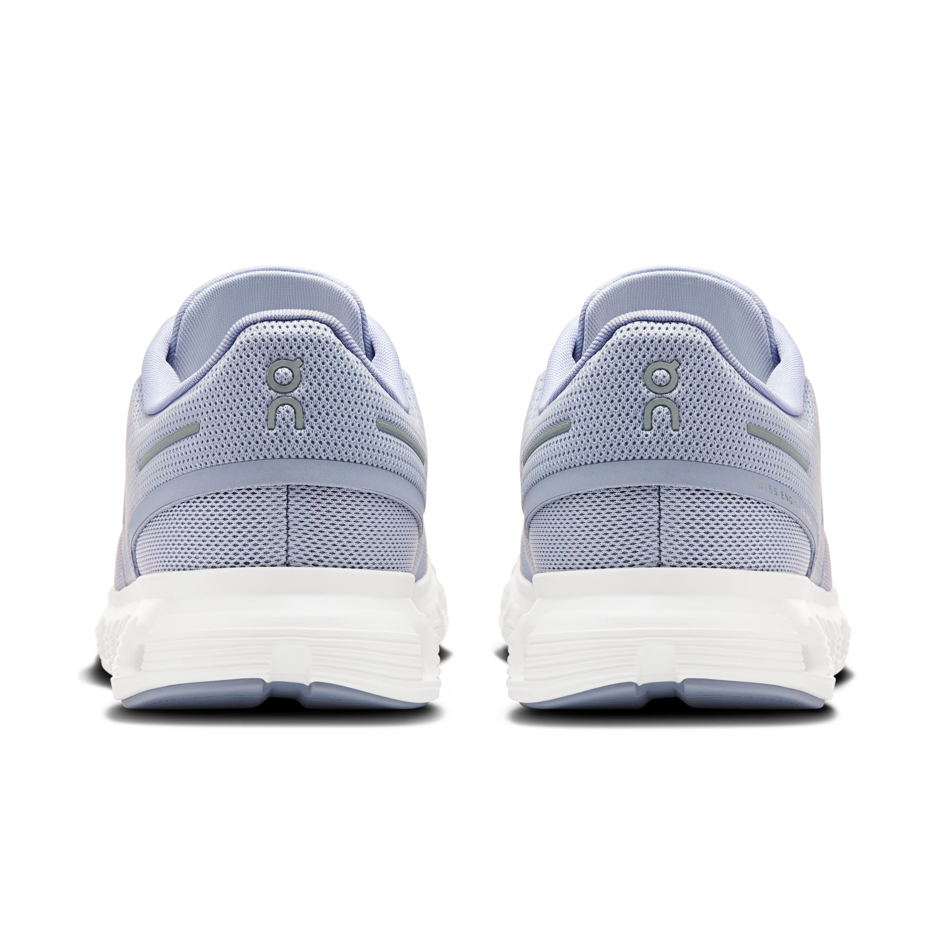 Pair of light blue sneakers with white soles on a white background