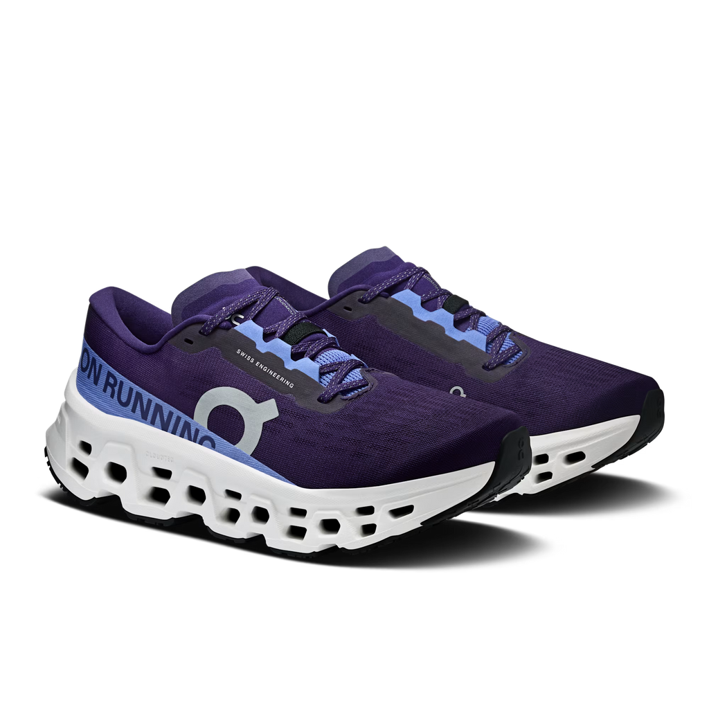 Purple running shoes with white soles on a white background