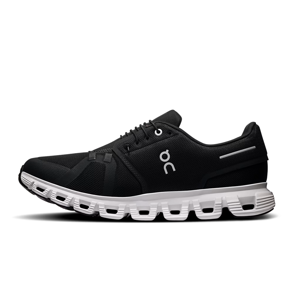 Black running shoe with white sole on a transparent background