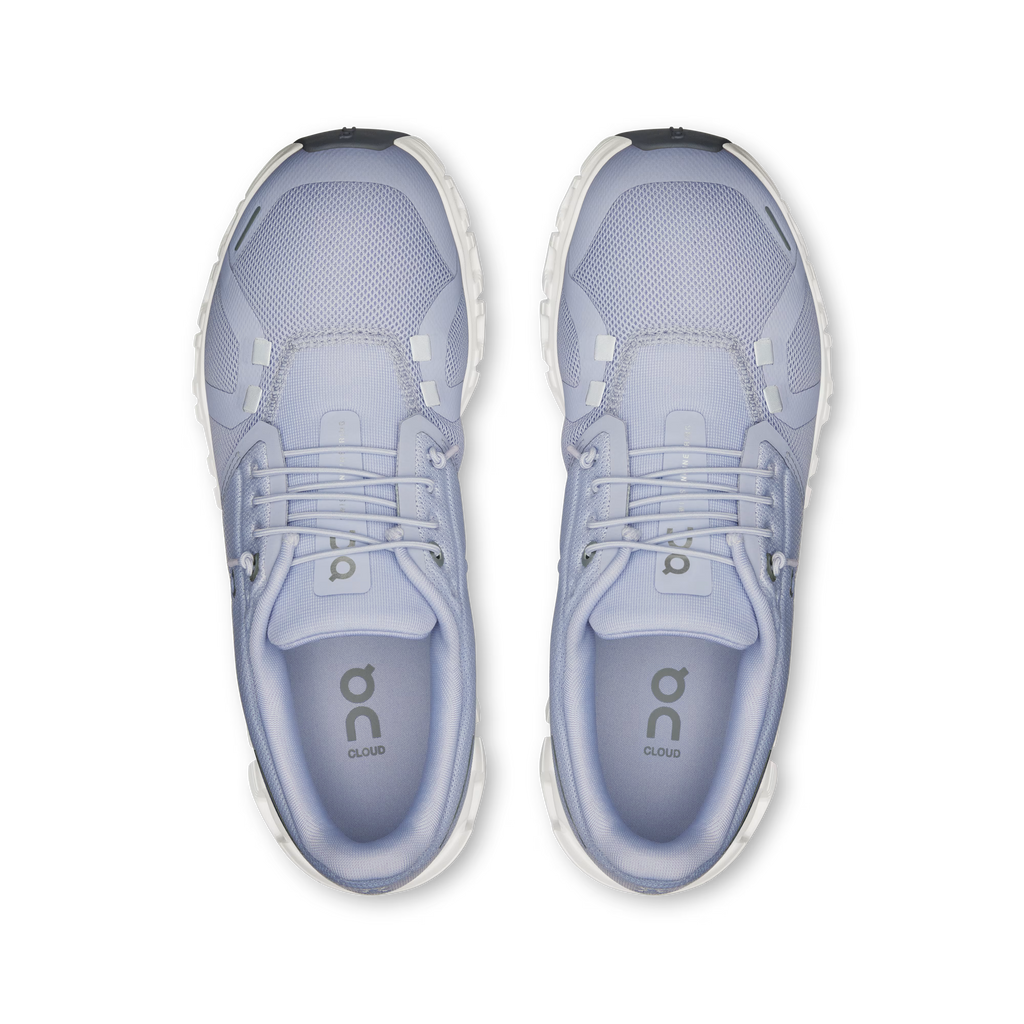Pair of light blue running shoes with 'On' branding on a white background