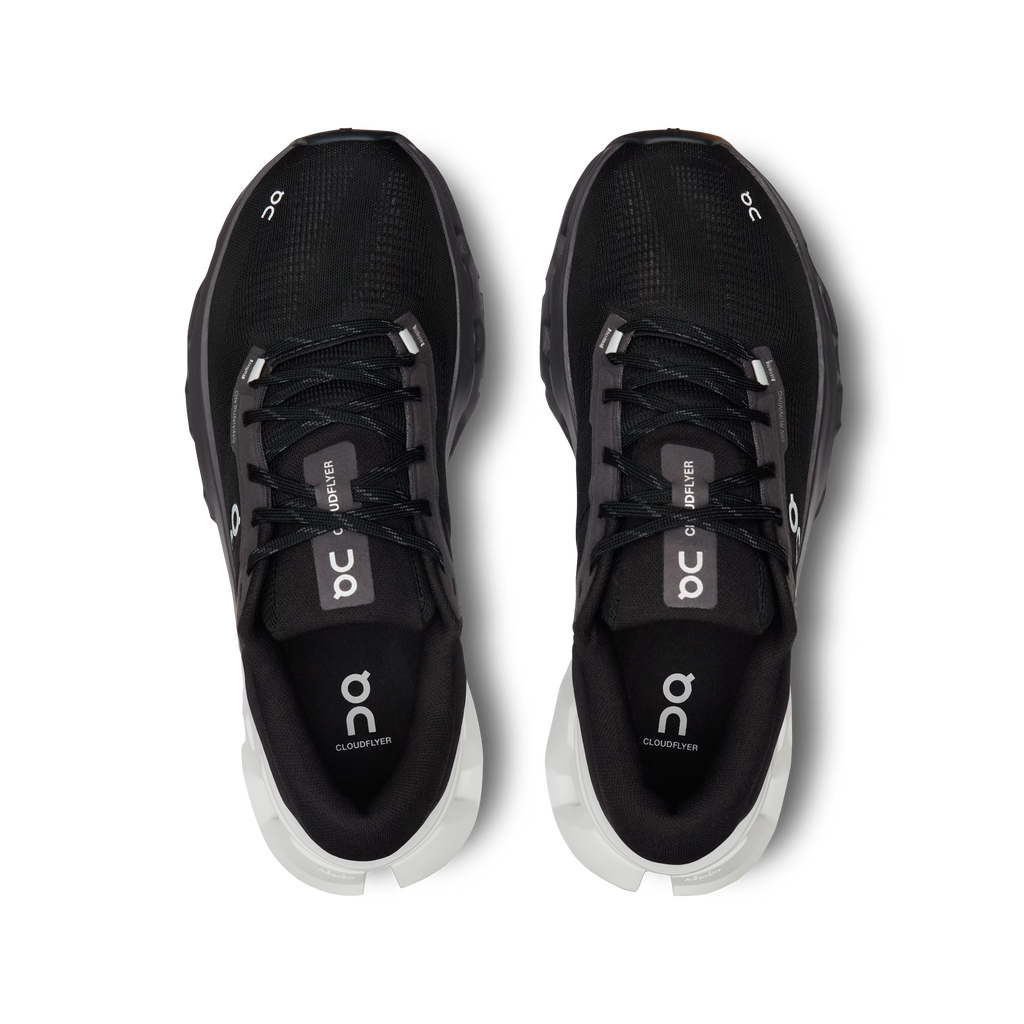 Black running shoes with white soles on a white background