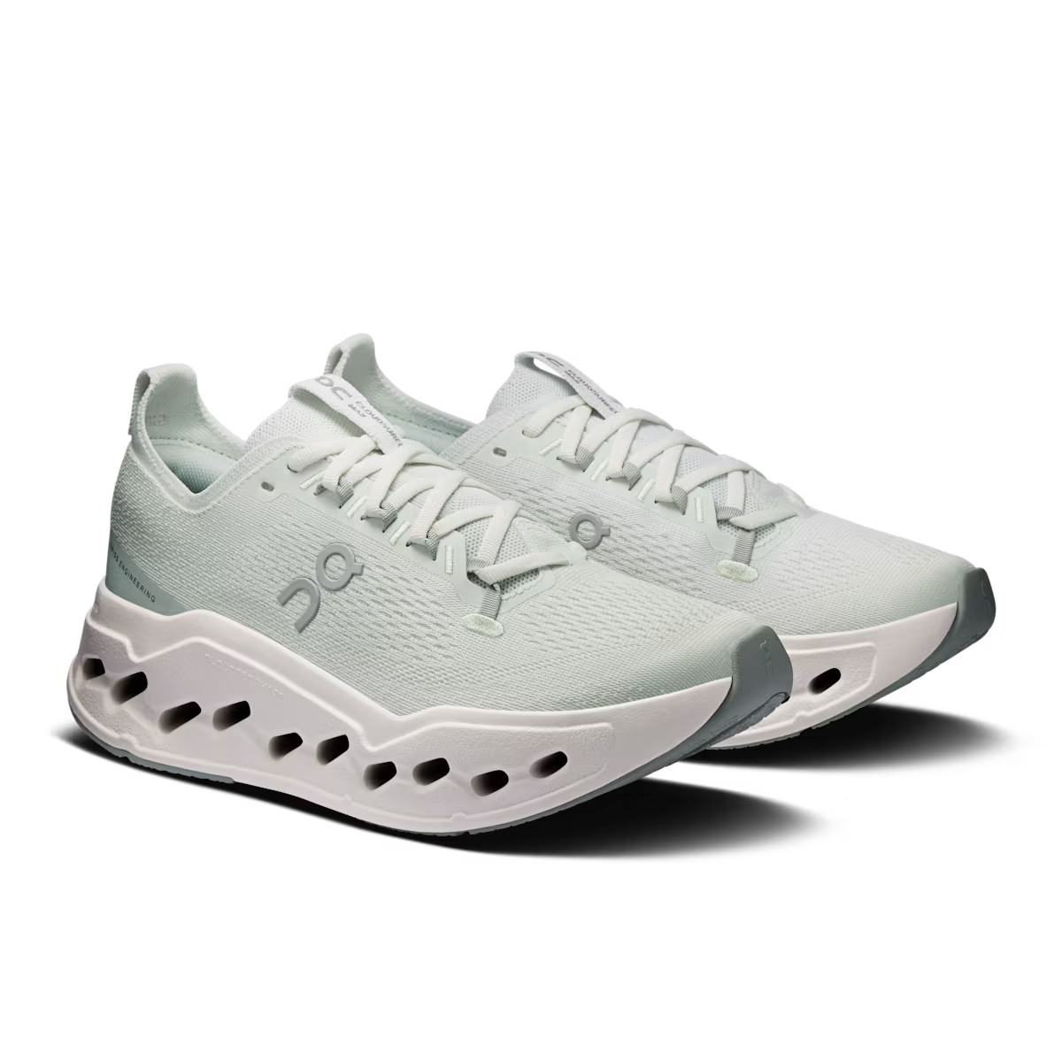 Light blue running shoes with white sole on a white background