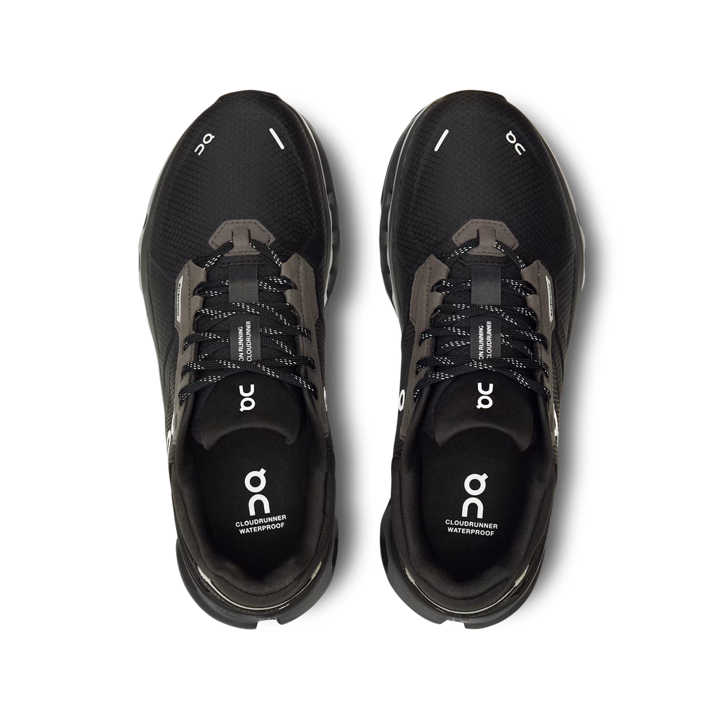 Black running shoes with 'on' branding on a white background