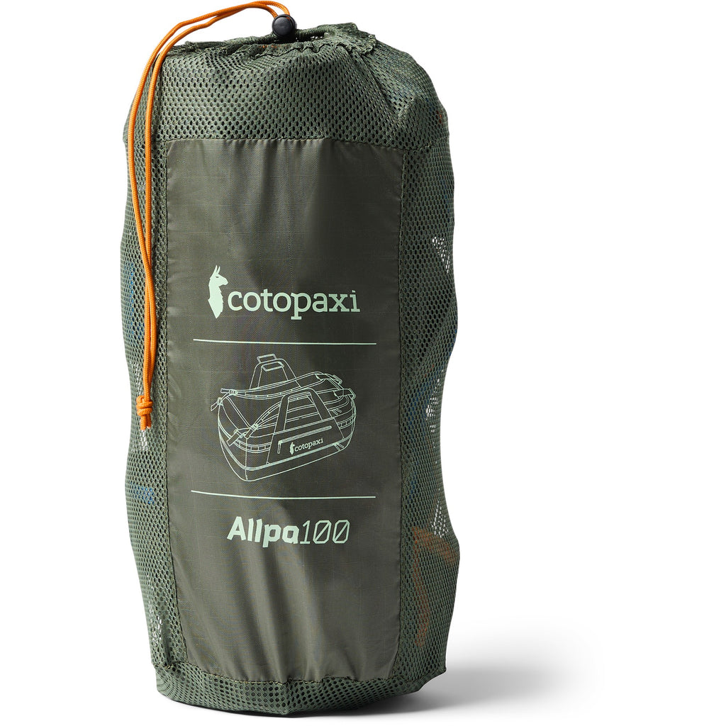 A green Cotopaxi Allpa 100 tent shown packed inside its matching green mesh drawstring bag with an orange drawstring, on a white background.