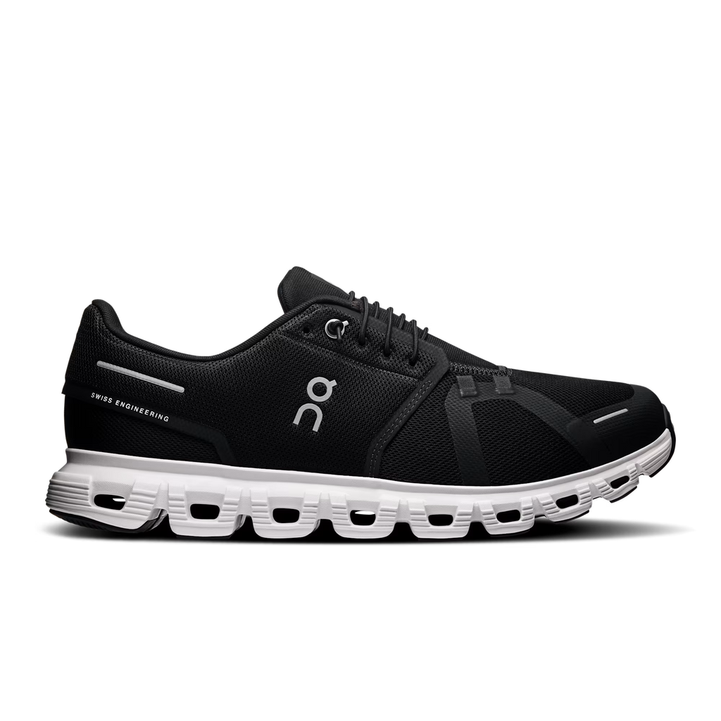 Black running shoe with white sole on a transparent background
