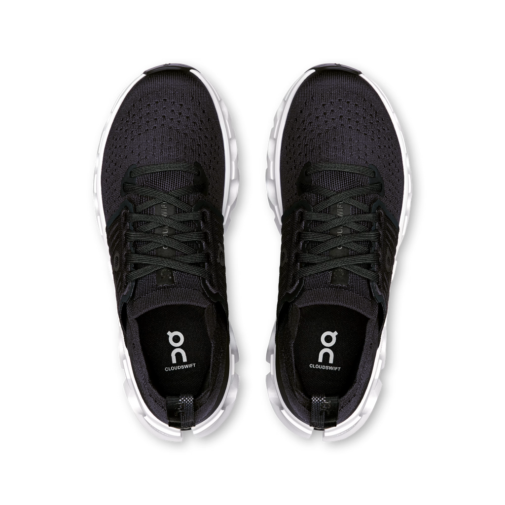 Black running shoes with white soles on a white background