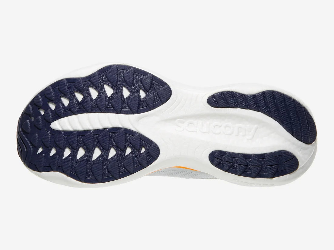 The outsole of a Saucony athletic shoe, featuring a white midsole with the Saucony brand name embossed and dark navy blue textured rubber outtrucks on the heel and forefoot.