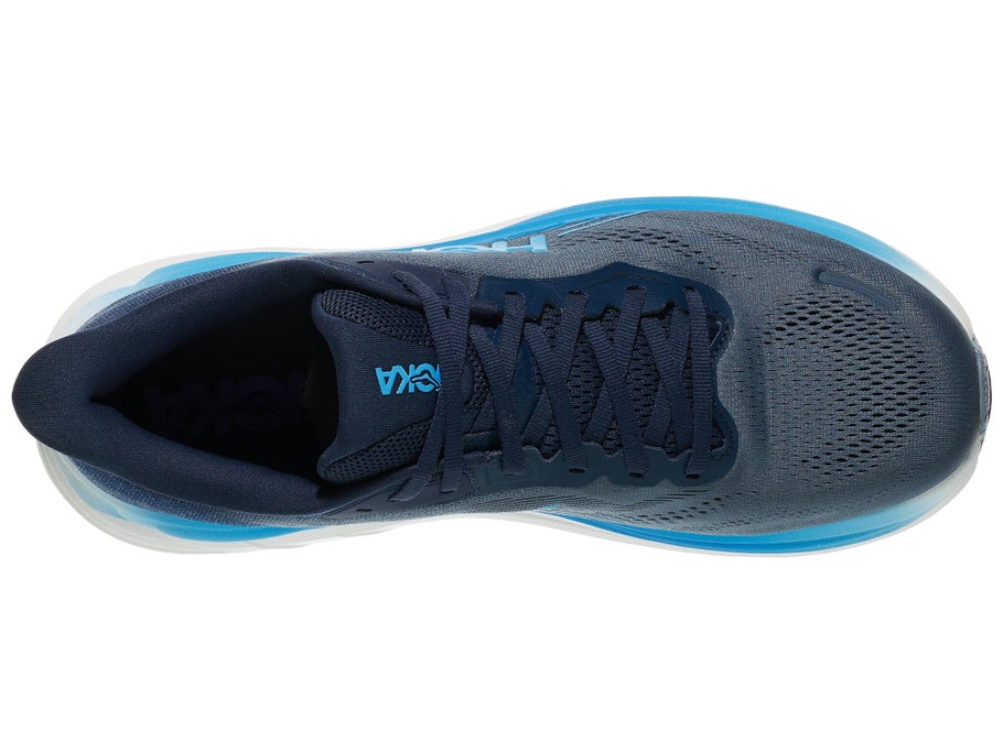 A top-down view of a Hoka running shoe in dark navy blue with bright blue accents on the midsole and tongue logo, set against a plain white background.