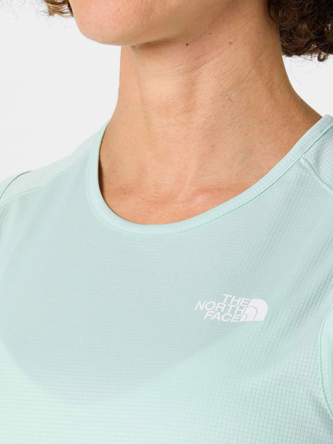 Light blue t-shirt with The North Face logo worn by a person