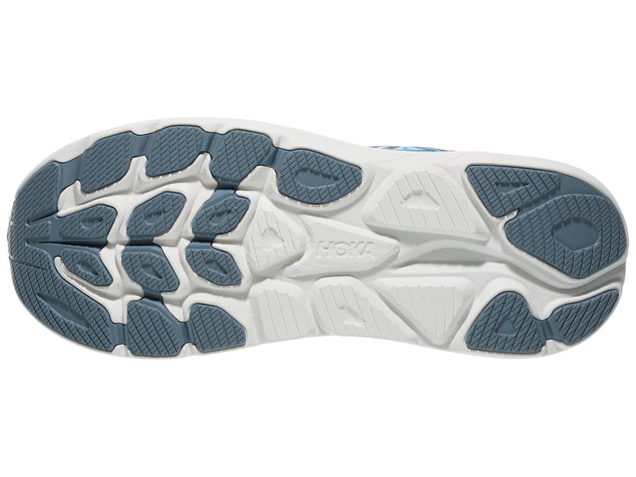 The outsole of a Hoka running shoe, featuring a white midsole with a textured dark slate blue-gray tread pattern.