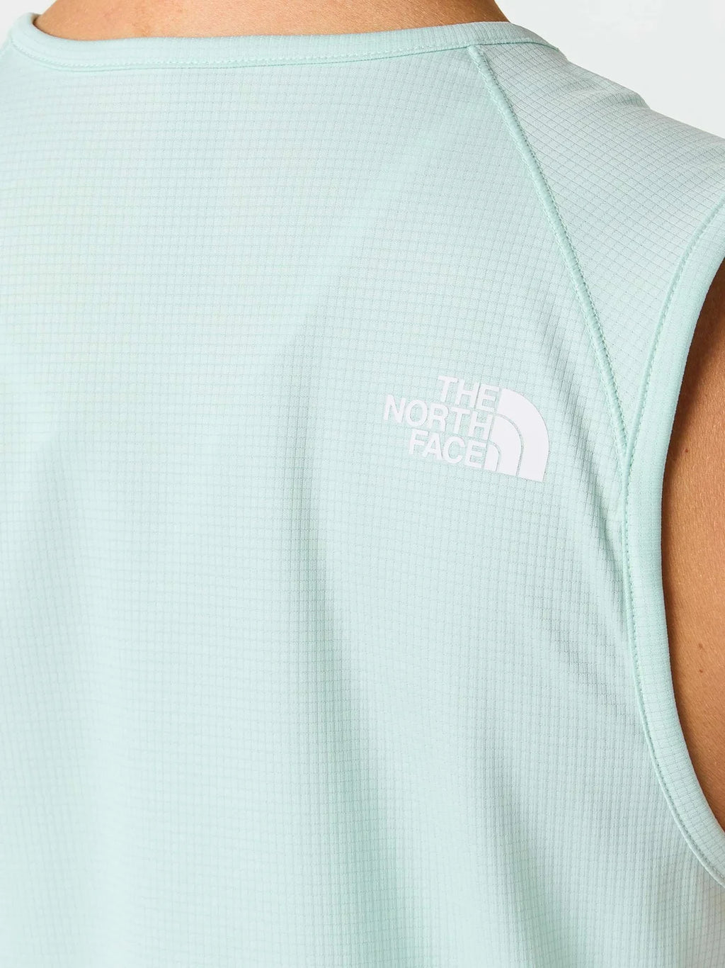 Light blue sleeveless shirt with The North Face logo on a white background
