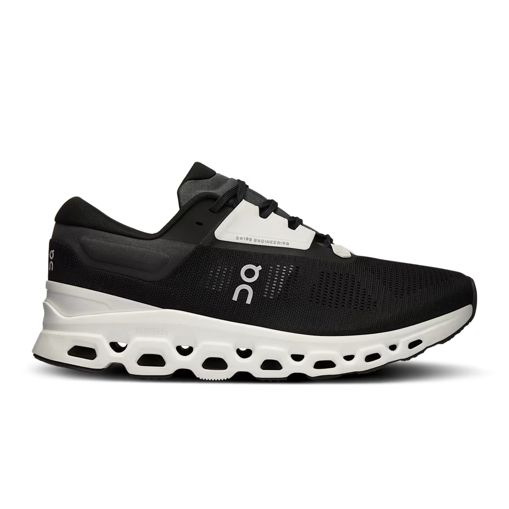 Black running shoe with white sole on a transparent background