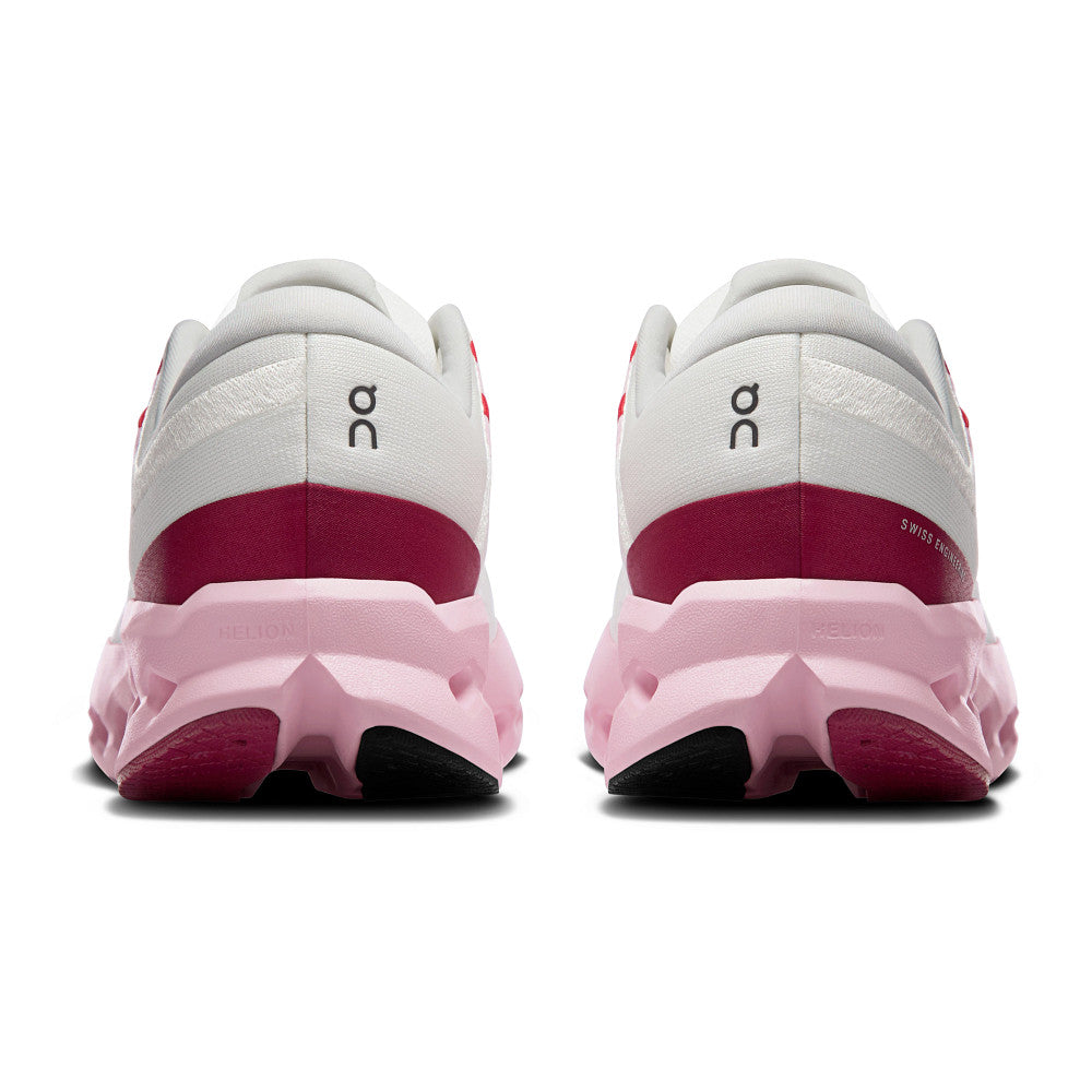 White and pink running shoes with 'on' branding on a white background
